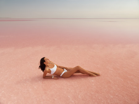 Fashion Bikini Spa Woman Relax on Pink Salt Lake, Beauty Treatmentの写真素材