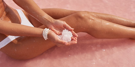 Close-Up Two Holding Hands a Rock of Salt From the Pink Salt Lakeの写真素材