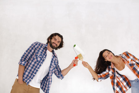 Cheerful Couple Working Together on Home Improvement Projectの写真素材