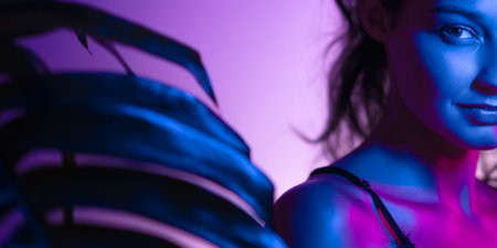 Mysterious Half-Face Portrait Of Woman In Neon Lightの写真素材