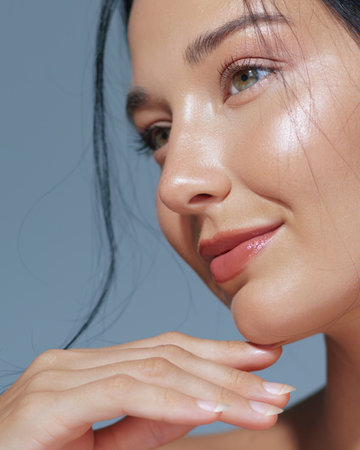 Asian Woman With Glowing Skin And Natural Makeup Posing Elegantlyの写真素材