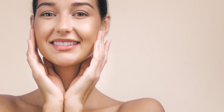 Radiant Woman Displaying Skincare Routine With Glowing Skinの写真素材