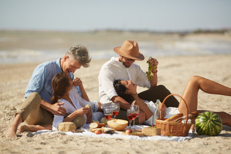 Best Friends And Couples Enjoying Valentines Day Beach Picnicの写真素材
