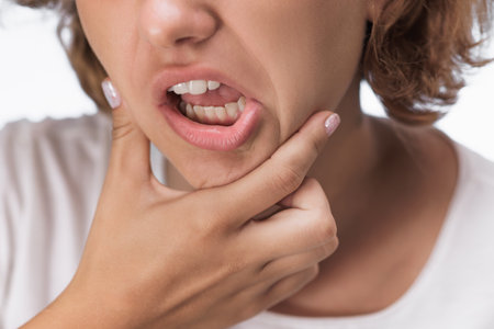 Young Woman Showing Displeasure and Pain in Her Mouth