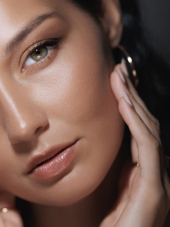 Woman with Natural Makeup Touching Face Close-Up for Beauty Campaign