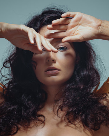 Brunette Woman With Hands Framing Face In Beauty Portraitの写真素材