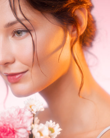 Close-Up Beauty Portrait Of Woman With Glowing Skin And Soft Floral Lightingの写真素材
