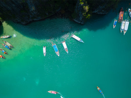 Aerial View of Boats Floating in Clear Turquoise Lagoon Near Rocky Cliffs