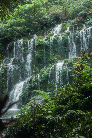 Defocused Vertical View of Banyu Wana Amertha Waterfalls in Bali Jungle