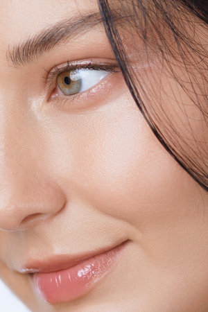 Extreme Closeup Of Woman s Eye And Glossy Lips With Perfect Skinの写真素材