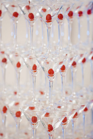 Close-Up Of Cocktail Glasses With Cherries In Elegant Pyramid Displayの写真素材
