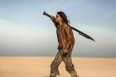 Fierce Post-Apocalyptic Woman With Sword Walking Across Desert Alone