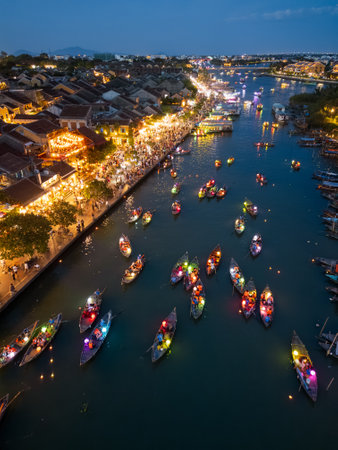 Lantern Boats and Glowing Streets in Night Aerial of Hoi An Vietnam Festivalの写真素材
