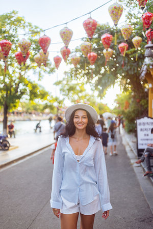 Charming Tourist Woman On Lantern Street In Hoi An Vietnam Smiling Brightlyの写真素材