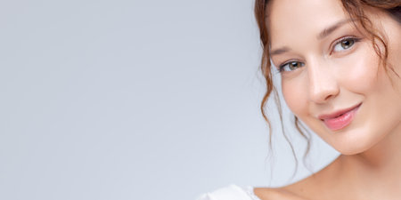 Beauty Banner With Smiling Woman And Glowing Skin On Soft Studio Backgroundの写真素材