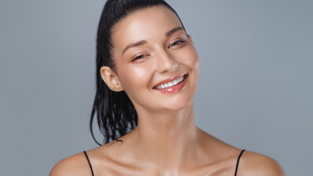 Cheerful Athletic Woman Smiling with Dewy Skin After Intense Workoutの写真素材