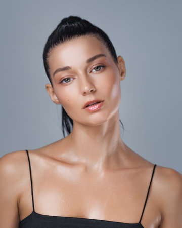 Sweaty Woman with Tired Expression After Intense Workout in Studio