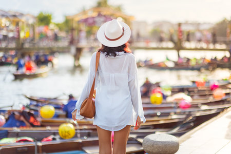 Stylish Woman Walking By Colorful Lantern Boats In Hoi An Vietnamの写真素材