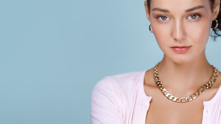 Closeup Portrait Of Stylish Woman In Pink With Gold Chain And Glowing Skinの写真素材
