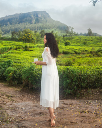 Barefoot Woman Enjoying Tea Among Misty Ceylon Plantation at Dawn