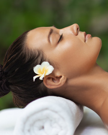 Side Profile Of Spa Woman Resting Peacefully With Flower In Hairの写真素材