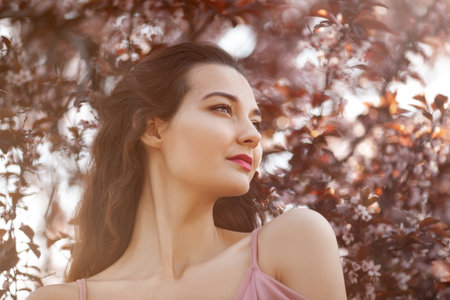 Romantic Beauty in Spring Garden Looking Away With Gentle Expressionの写真素材