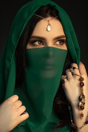 Mystical Woman in Green Veil With Beads and Pearl Jewelry in Studioの写真素材