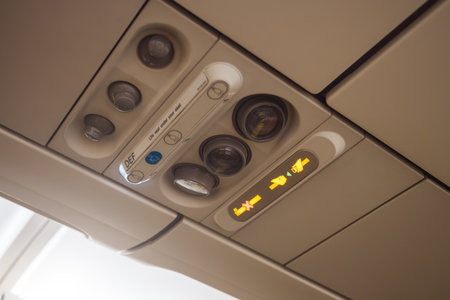 Airplane Overhead Panel With Seatbelt And No Smoking Signs Illuminatedの写真素材