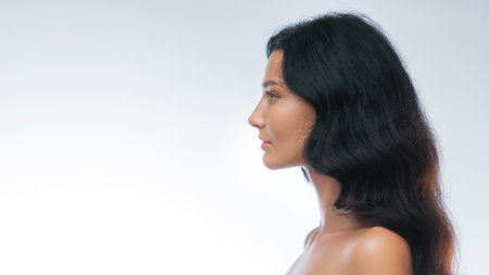 Studio Profile Portrait Of Woman With Glowing Skin And Text Space On Side