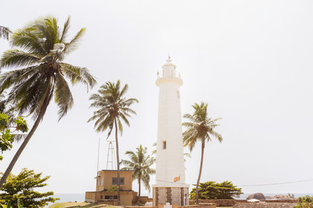 White Lighthouse at Galle Fort Sri Lanka Surrounded by Palm Treesの写真素材