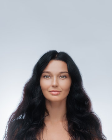 Front-Facing Beauty Portrait Of Woman With Long Healthy Hair And Clear Skinの写真素材