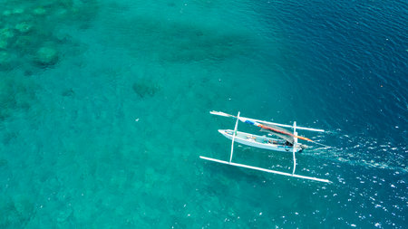 Drone Shot Of Jukung Outrigger Sailing Over Turquoise Amed Reef, Bali