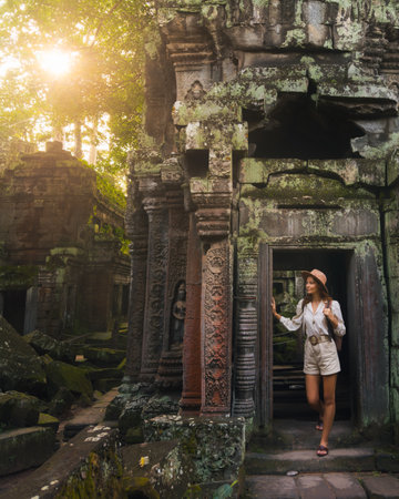 Ta Prohm Angkor Wat Cambodia Temple With Female Traveler At Sunriseの写真素材