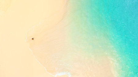Aerial Minimalist Beach Scene With Woman And Turquoise Tropical Seaの写真素材