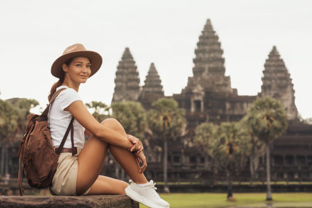 Smiling Female Traveler Relaxing At Angkor Wat Temple In Cambodiaの写真素材
