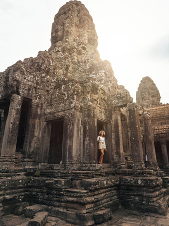 Solo Backpacker Exploring Bayon Temple Ruins, Angkor Thom, Cambodiaの写真素材