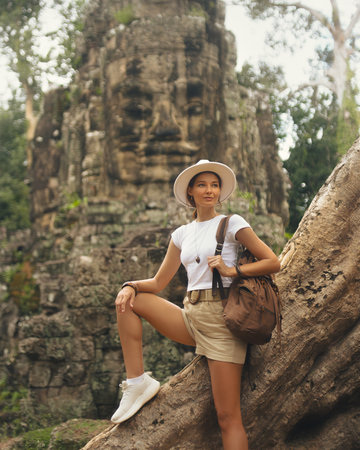 Female Traveler at Victory Gate Bayon, Angkor Thom, Cambodia Travel Conceptの写真素材