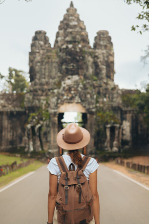 Angkor Thom Gate With Female Traveler, Bayon Face Towers, Cambodia Tourismの写真素材