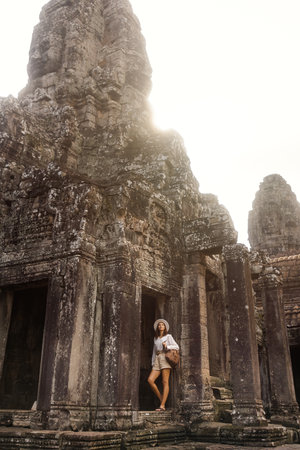 Solo Female Traveler At Bayon Temple In Angkor, Cambodia At Sunriseの写真素材