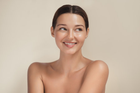 Smiling Woman With Natural Glowing Skin Looking Away In Beauty Shotの写真素材