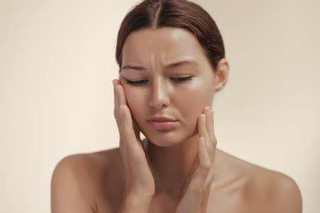 Sad Woman Holding Cheeks In Emotional Beauty Portrait With Self-Doubt Expressionの写真素材
