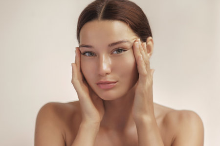 Woman Stretching Skin Near Eyes With Hands In Facial Lifting Skincare Conceptの写真素材