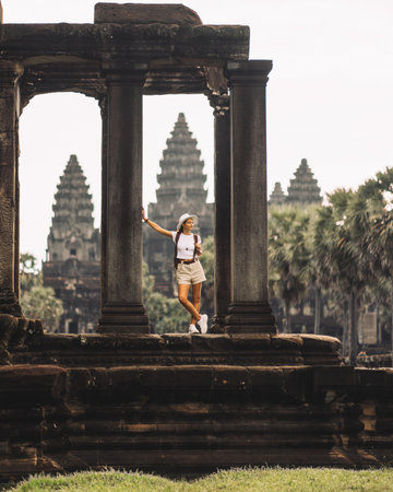 Female Traveler Framed By Columns At Angkor Wat, Cambodia Travel Editorialの写真素材