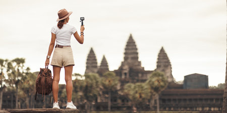 Angkor Wat Vlogger: Female Traveler Filming Iconic Temple, Cambodiaの写真素材