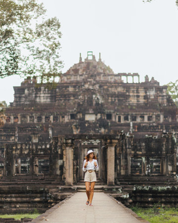 Baphuon Temple Causeway With Female Traveler, Angkor Thom UNESCO Siteの写真素材