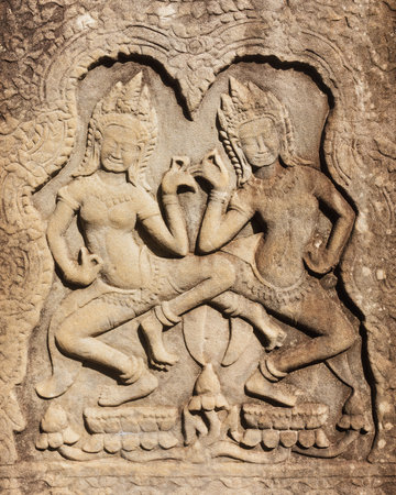 Intricate Apsara Stone Relief Dancing at Angkor Wat Temple Wallの写真素材