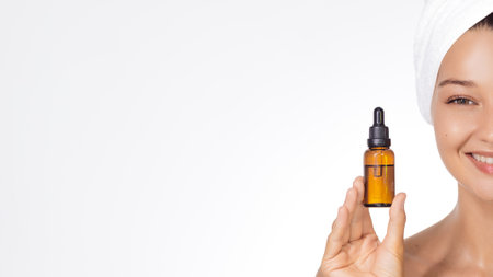 Smiling Woman Holding Serum Bottle For Clean Beauty Skincare Bannerの写真素材