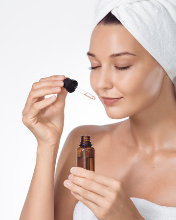 Skincare Serum Application With Amber Dropper, Towel-Turban Womanの写真素材