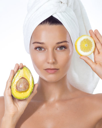 Title Spa Woman Holding Avocado and Lemon in Towel for Natural Skincareの写真素材