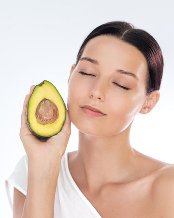 Natural Avocado Skincare Woman With Fresh Face On White Backgroundの写真素材
